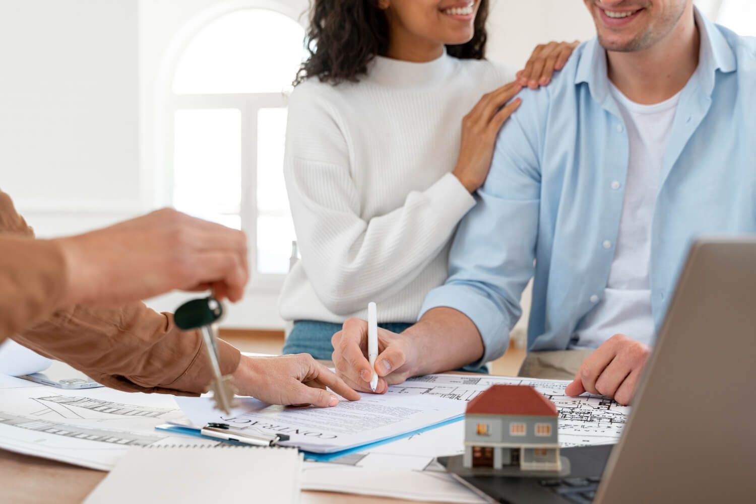 smiley-couple-signing-contract-new-house (1)